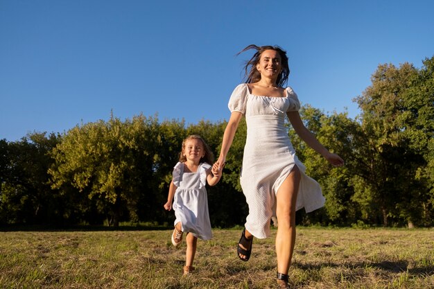 Front view smiley woman with girl