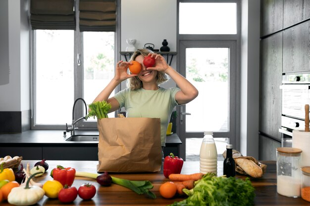 Front view smiley woman with groceries