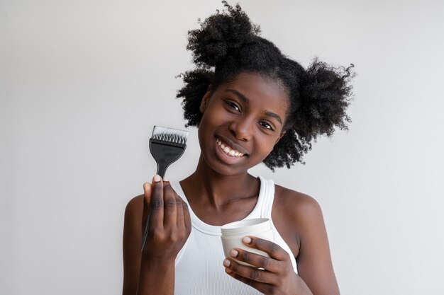 Front view smiley woman with hair product