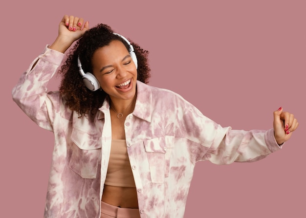 Front view of smiley woman with headphones having fun