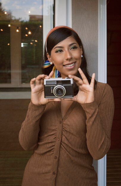 Front view smiley woman with photo camera