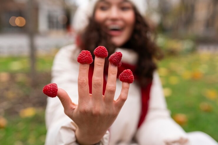 Free Photo front view smiley woman with raspberries