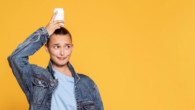 Front view of smiley woman with soda can and copy space