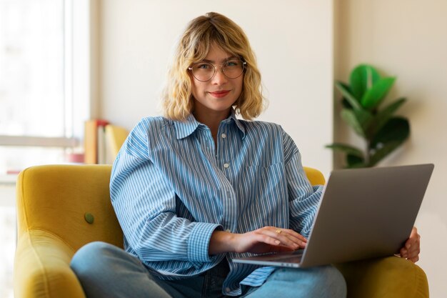 Front view smiley woman working on laptop