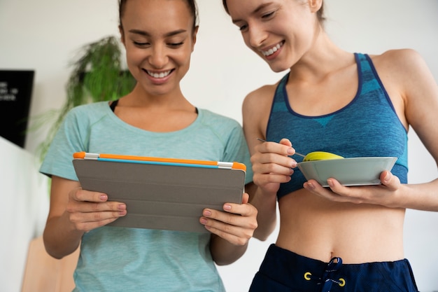 Front view smiley women with tablet