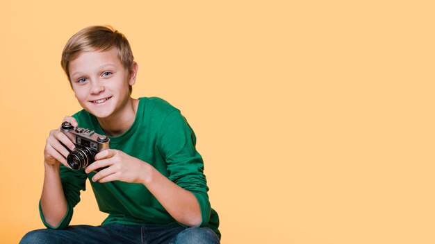 Front view of smiling boy looking away with copy space