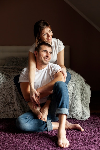 Free photo front view smiling couple looking away