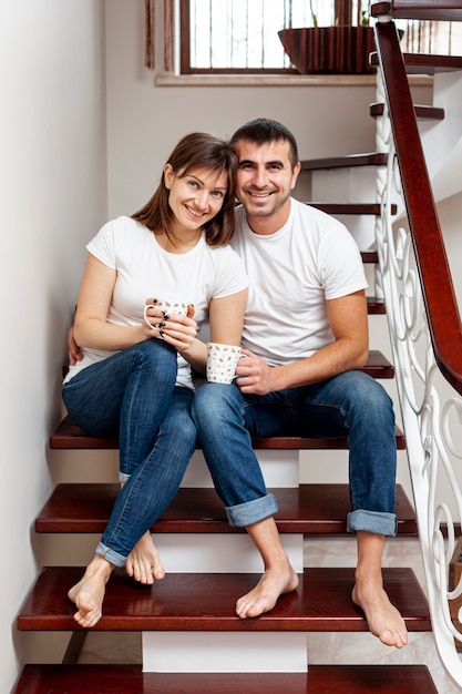 Front view smiling couple looking at photographer