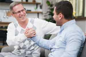 Free photo front view of smiling father and son