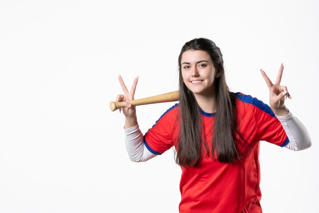 Front view smiling female player with baseball bat