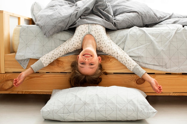 Front view of smiling girl in bed