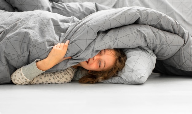 Front view of smiling girl in bed