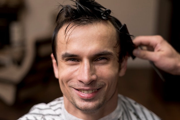 Front view smiling man at hairsalon