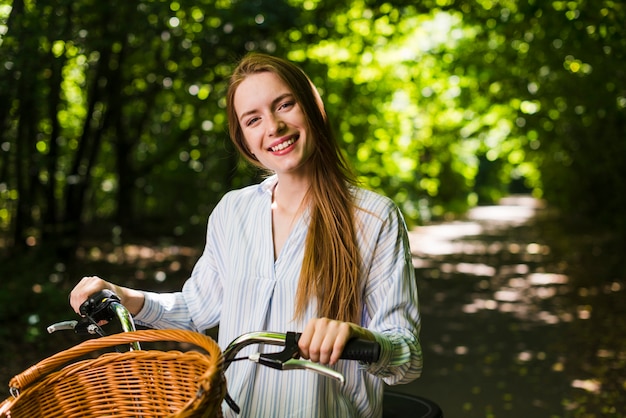Front view smiling woman on bike