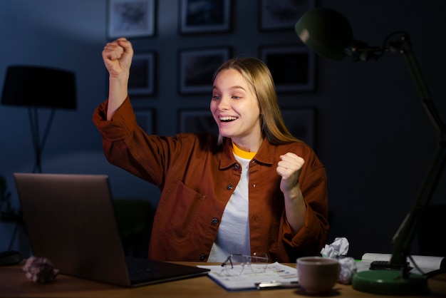 Front view of smiling woman at desk