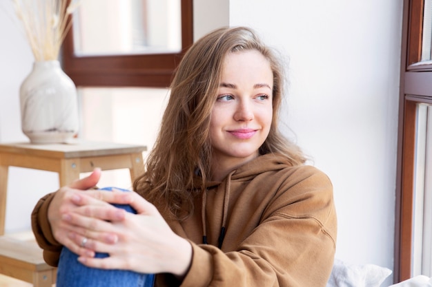 Front view of smiling woman at home