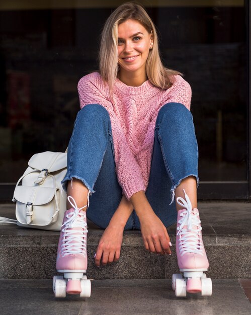 Front view of smiling woman in roller skates