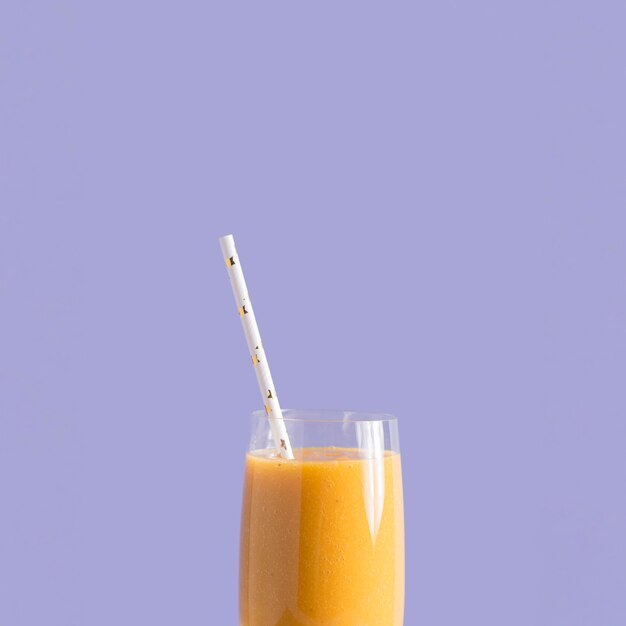 Front view smoothie in glass with straw