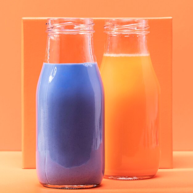 Front view smoothies in glass bottles