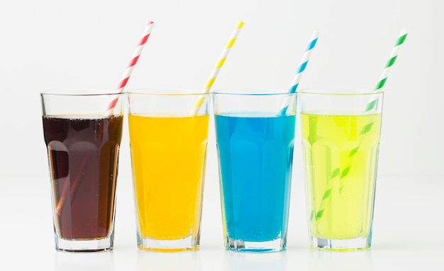 Front view of soft drinks in glasses with straws