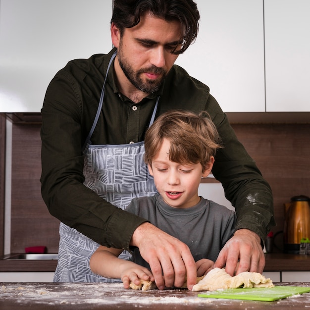 Front view son and father baking at home