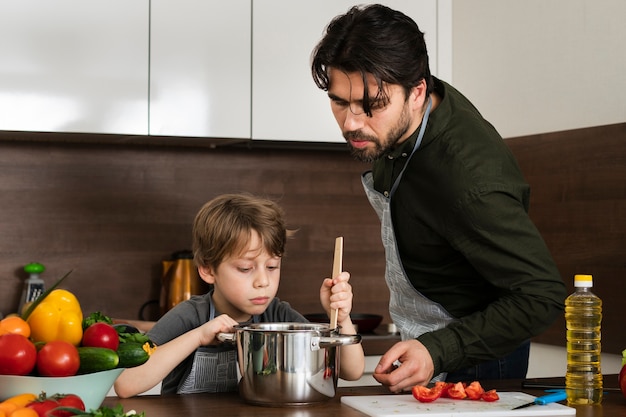 Front view son and father cooking