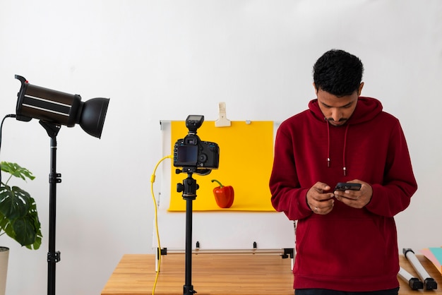 Front view specialized photographer working in studio