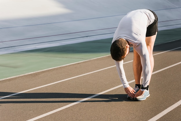 Front view of sporty man doing stretches