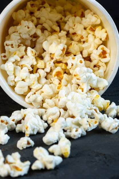 Front view sprinkled popcorn from a bucket