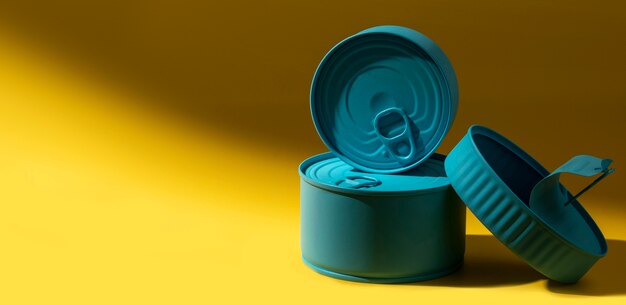 Front view stack of blue tin cans with copy-space