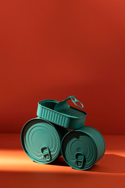 Front view stack of blue tin cans with copy-space