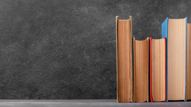 Front view of stack of books with copy space