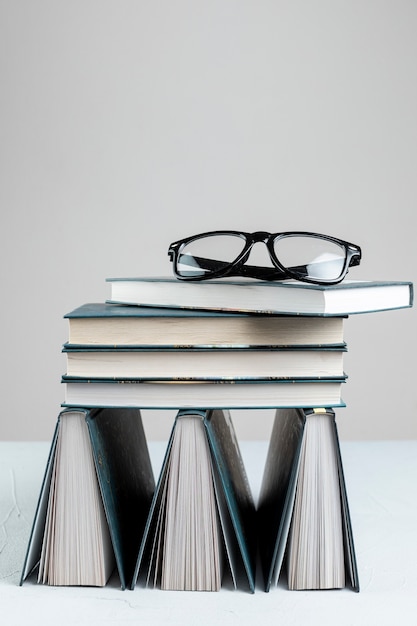 Free photo front view stacked books with grey background