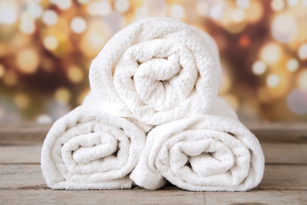 Free photo front view stacked towels with bokeh background