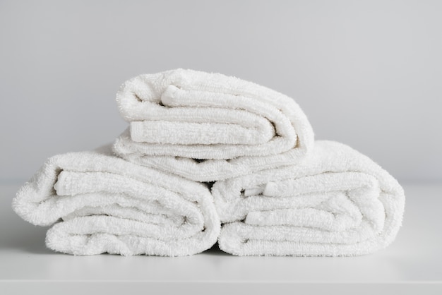 Free photo front view stacked white towels