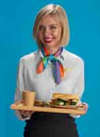 Free photo front view stewardess holding food