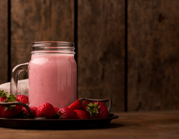 Front view of strawberry milkshake with copy space