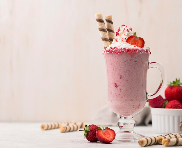 Free photo front view of strawberry milkshake with copy space