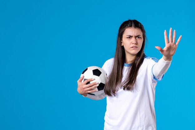 Front view stressed young female with soccer ball