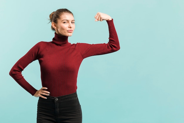 Free photo front view strong woman in studio