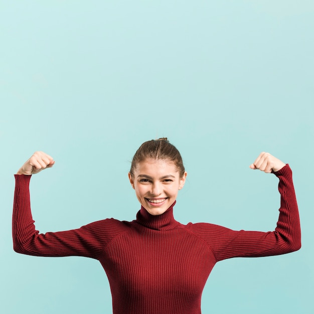 Free photo front view strong woman in studio