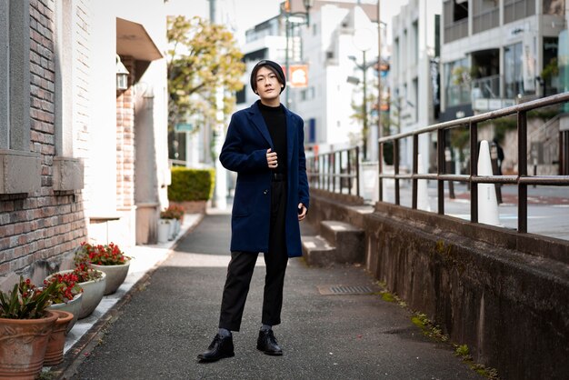 Front view of stylish man posing outdoors