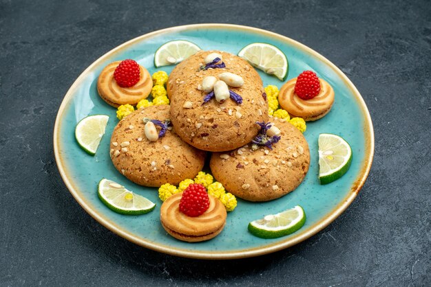 Front view sugar cookies with lemon slices on grey surface pie cookie biscuit sweet cake