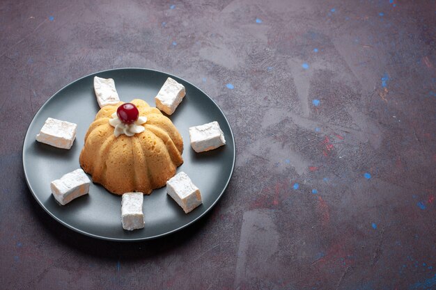 Front view sugar powdered candies delicious nougat with cake inside plate on the dark surface