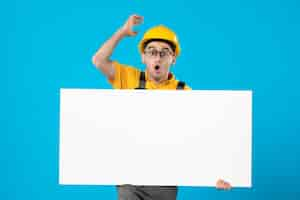 Free photo front view of surprised male builder in yellow uniform with plan blue