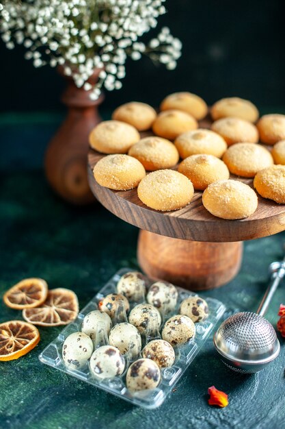 Front view sweet biscuits with nuts and milk on dark blue surface