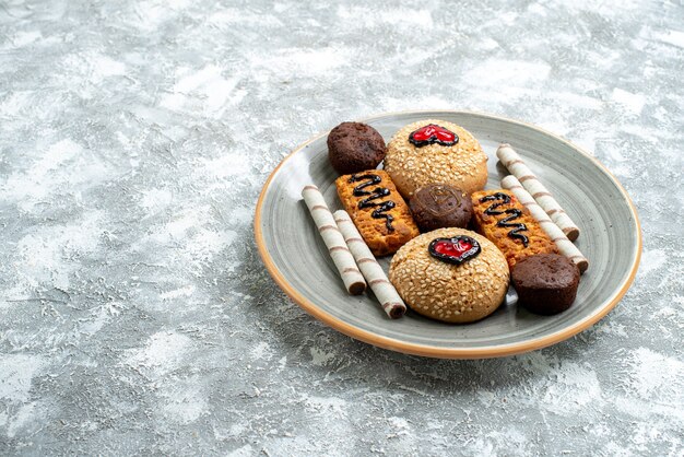 Front view sweet cookies inside plate on light-white space