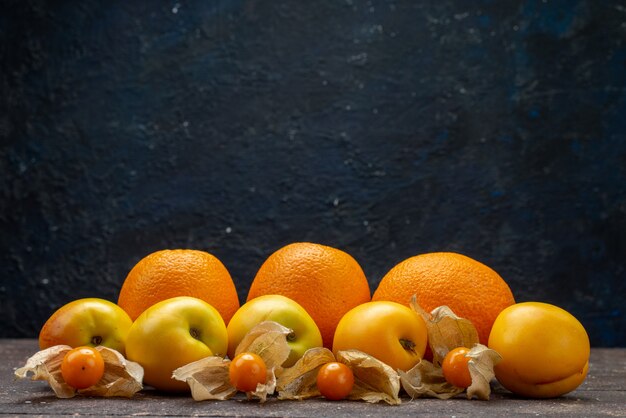 Вид спереди сладкие спелые абрикосы оранжевого цвета с апельсинами и вкусными летними фруктами физализа на коричневом