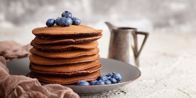 Front view sweet pancakes tower arrangement with copy space