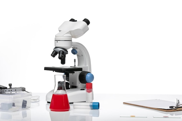 Free photo front view table with solutions and microscope on white space